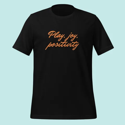 Black tee with "Play, joy, positivity" hand-signed across the chest